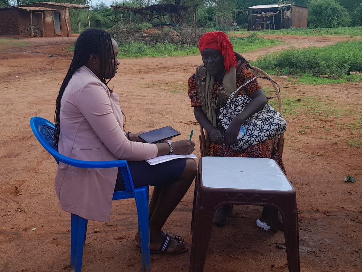 Enumerator conducting a household listing interview.